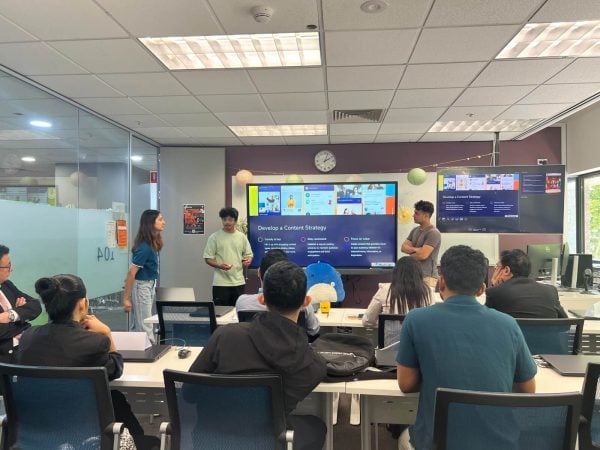 KOI students presenting their work to a group
